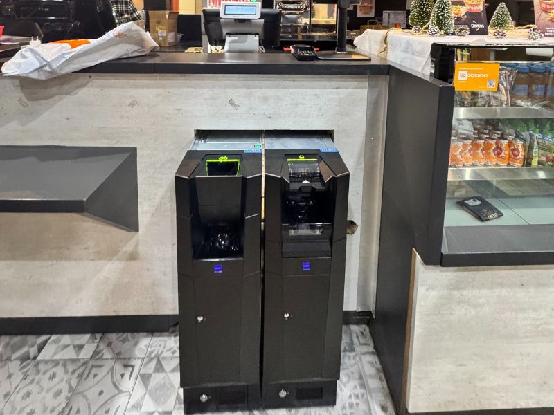 Monnayeur automatique moderne intégré au comptoir d’un fast-food à Lyon